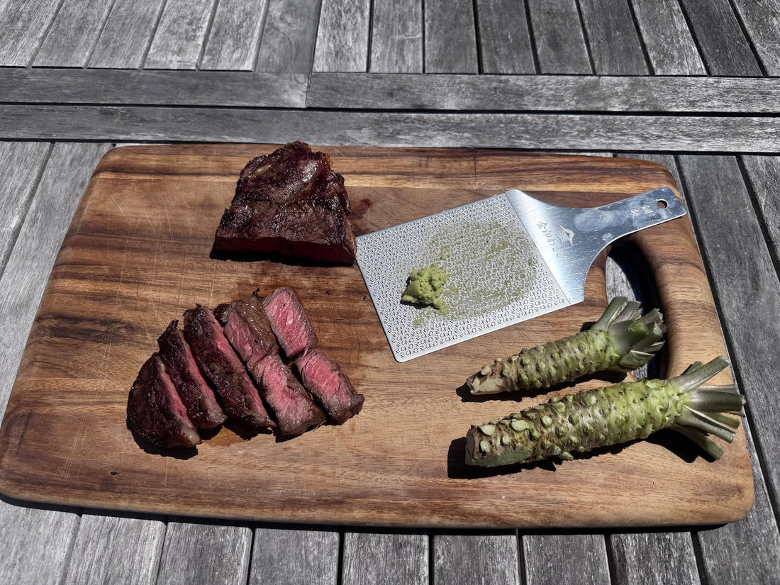 Grated real wasabi on a cutting board with one sliced NY strip steak